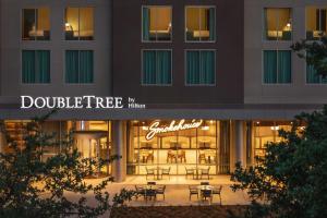 a store front of a building with tables and chairs at Doubletree By Hilton Abilene Downtown Convention Center in Abilene