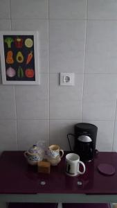 a table with two cups and a bowl on it at Piso con Encanto en Coruña. in A Coruña +32 photos