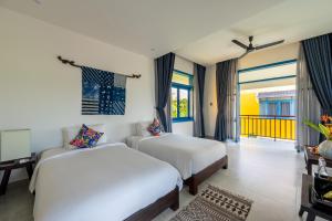 Postel nebo postele na pokoji v ubytování Chez Mimosa Hoi An - LUA Retreat