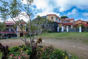 a house on top of a hill with flowers at Le Tropical Chez Jeannette in Rodrigues Island