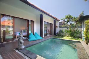 a pool in the backyard of a villa at Villa Lotus Flower Sanur in Sanur