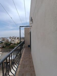 a balcony of a building with a door on it at Serene apartment in Haz-Zebbug in Taʼ Srina