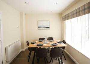 a dining room with a table and chairs at Seafront Sanctuary Ballycastle in Ballycastle