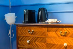 a wooden dresser with a coffee maker on top of it at Starguest Dante in Naples