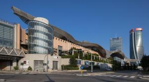 a building with a curved roof on a city street at Residenza Vigliani in Milan