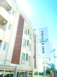a large building with a sign in front of it at Premier İnn Cİty in Antalya