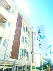 a large building with a sign in front of it at Premier Inn City Antalya in Antalya