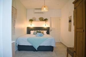 een slaapkamer met een bed met een blauwe deken bij Caribbean Happyness in Willemstad +51 foto's