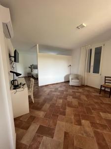 a living room with a tile floor at AFFITTACAMERE SAN MAMANTE in Santa Lucia delle Spianate