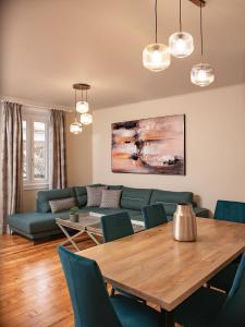 a living room with a table and a couch at Corfu Liston Old Town Apartment in Corfu Town
