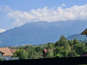 a view of a mountain range with houses and trees at Maricom Home in Zărneşti