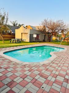 a swimming pool with a hose in a yard at Soft petal in Pretoria