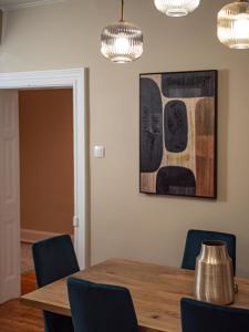 a dining room with a wooden table and blue chairs at Corfu Liston Old Town Apartment in Corfu Town