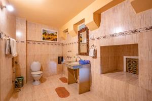 a bathroom with a toilet and a sink at Hotel Garh Jaisal Haveli in Jaisalmer