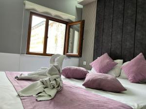 a stuffed animal is sitting on a bed with pillows at The Zanadu İstanbul in Istanbul