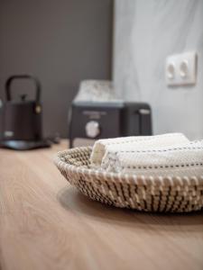 a basket sitting on a wooden table with a appliance at Corfu Liston Old Town Apartment in Corfu Town +13 photos