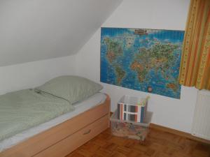 a bedroom with a bed and a map on the wall at Ferienhaus Duhra in Peitz