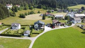 an aerial view of a house on a green field at Fritz Apartments "Haus Bergblick" in Hermagor