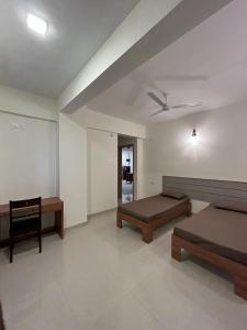 a room with two beds and a ceiling fan at Cinnamon House in Pune +36 photos