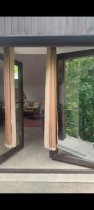 a screened in porch with windows and a couch at Casa de Piatra in Socolari