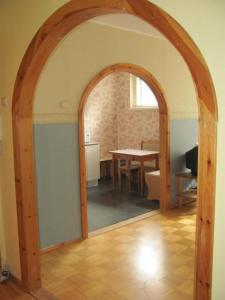 an archway leading into a dining room with a table at Economy Baltics Apartments - Liivamäe in Tallinn
