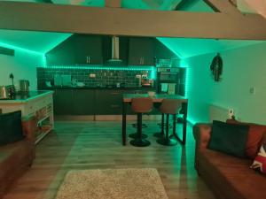 a kitchen with blue lighting in a room with a couch at The Granary in Buckley