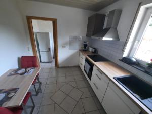 a kitchen with a table and a counter top at Fewo Lerchi am Nürburgring in Kelberg