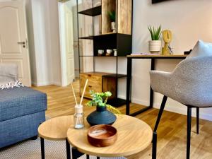 a living room with a blue couch and a table at Luxury Style 2 Room Apartment by R&L in Centre in Leipzig