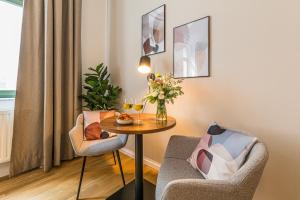 a small room with a table and two chairs at Luxury Style 2 Room Apartment by R&L in Centre in Leipzig