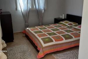 1 dormitorio con 1 cama con edredón en Εξοχικό MARIA, en Ambelákia