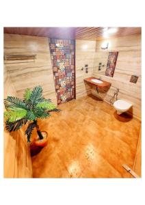 a bathroom with a potted plant and a sink at Knights Villa 5BHK in Chauk