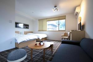 a hotel room with a bed and a couch at Sweet Stay Kyoto - Vacation STAY 21712v in Kyoto