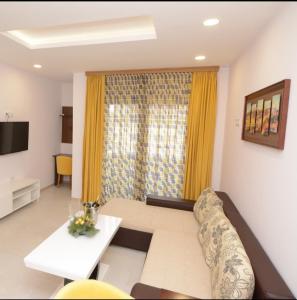 a living room with a couch and a table at Hotel Rafaelo in Bosanska Dubica