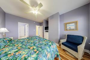 a bedroom with a bed and a blue chair at Purple House East and West in Fort Morgan