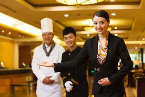 a group of three chefs standing in a kitchen at HOTEL ViA in Ansan