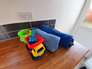a toy truck sitting on the floor in a room at Fabulous family house next to the beach in Nottage +16 photos