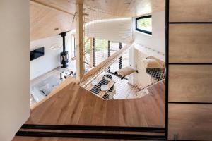 a view of the living room from the loft of a tiny house at Szőcs-birtok Apartments in Izvoare