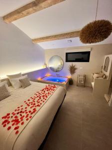 a bedroom with a bed with a pool and a tv at Le Clos des Délices - Love Room in Aubagne