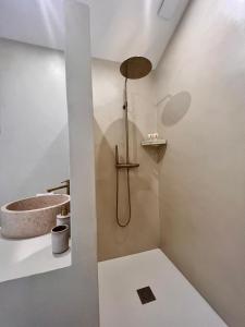 a bathroom with a shower and a sink at Le Clos des Délices - Love Room in Aubagne