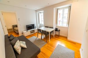 a living room with a couch and a table at Golden Place - Cacilhas in Almada