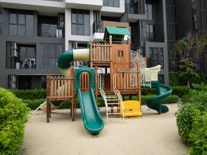 a playground with a slide in front of a building at Comfortable apartments in Laguna Skypark in Phuket Town