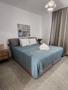 a bedroom with a bed with two towels on it at Adamandri Lodge - Prime Location in Ayia Napa