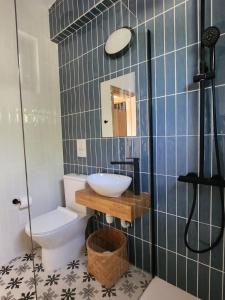 a bathroom with a sink and a toilet at Adamandri Lodge - Prime Location in Ayia Napa