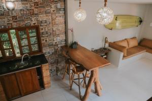 a kitchen with a wooden table in a room at Vila hangloose Jericoacoara in Acaraú +26 photos