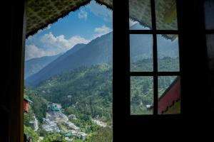 a view from a window of a mountain valley at JOYstels Kasol in Kasol