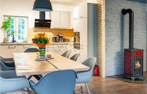 a dining room with a table and chairs and a stove at Pet Friendly Home In Hirtenberg With Kitchen in Hirtenberg