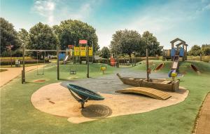 a park with a playground with slides and a play area at De Lindenhoeve in Sint-Katelijne-Waver