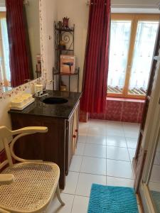 Un baño con un lavabo y una silla en una habitación. en La Marine Louannec, en Louannec 81 fotos más