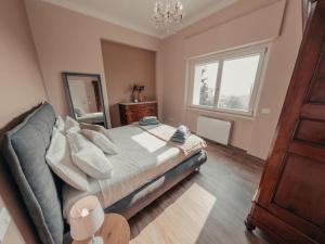 a bedroom with a large bed and a window at Villa Luxury Vista Vigneti-Piscina Privata in Agliano Terme +54 photos