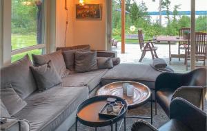 a living room with a couch and two tables at Stunning Home In Grdinge With Kitchen 